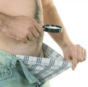 A man looks down his pants and wants to enlarge his penis with gel